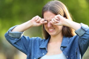 Woman,Suffering,Itching,Scratching,Eyes,Outdoors,In,A,Park