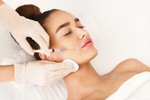 Woman with eyes closed getting BOTOX injections due to facial spasms