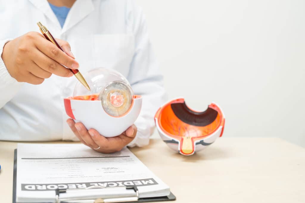 A female doctor at a desk in a hospital, discussing eye diseases