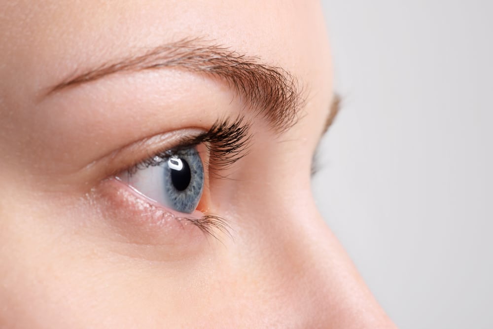 Woman has thick, full lashes that enhance her appearance.